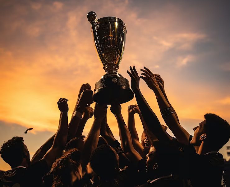 soccer-players-celebrating-victory-with-trophee_23-2150821488